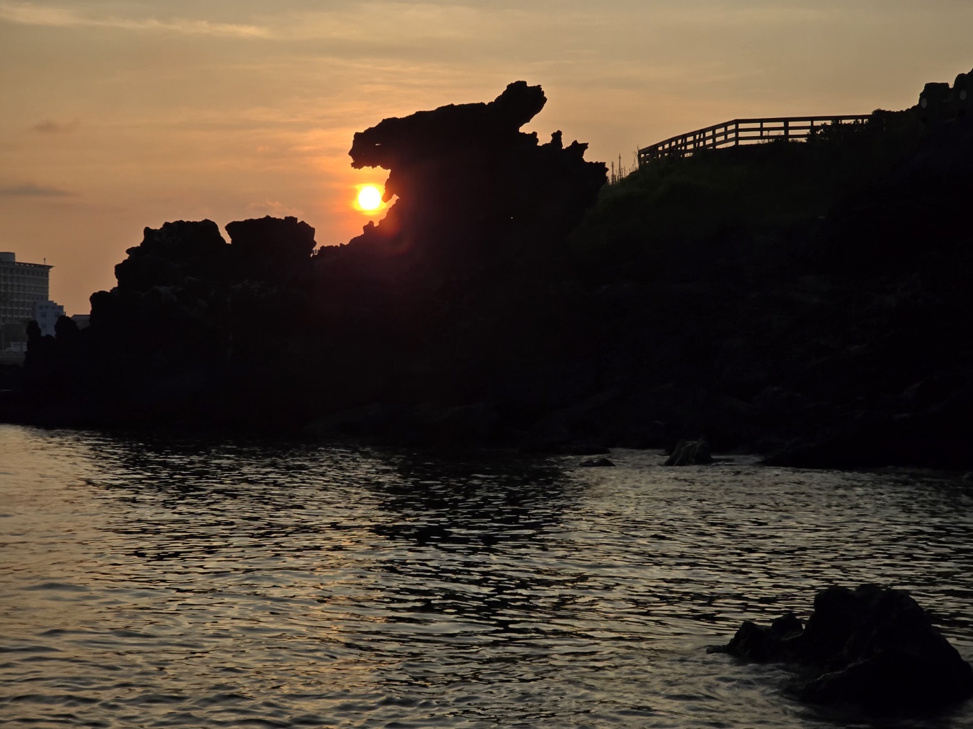 Yongduam Dragon Head Rock formation on Jeju northern coastline at sunset